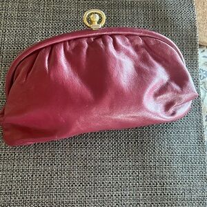 Pink “leather” clutch.